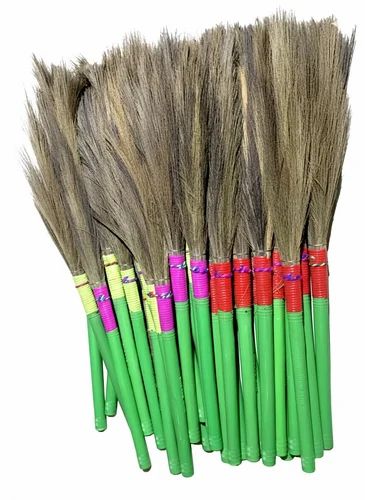 Finished grass brooms with green handles